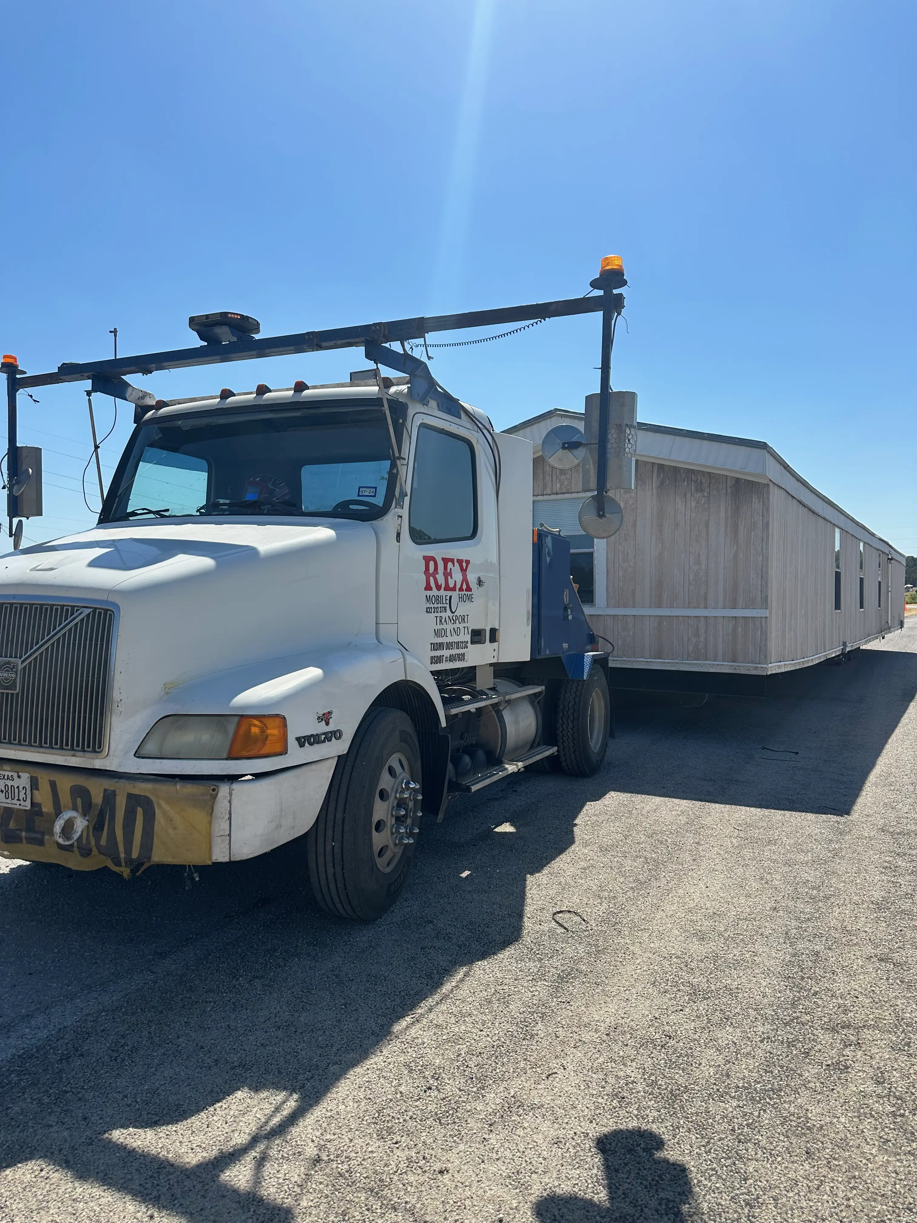 Commercial truck hauling a mobile home.